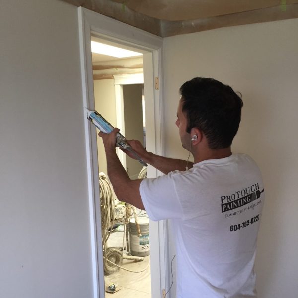 Caulking of door frame.